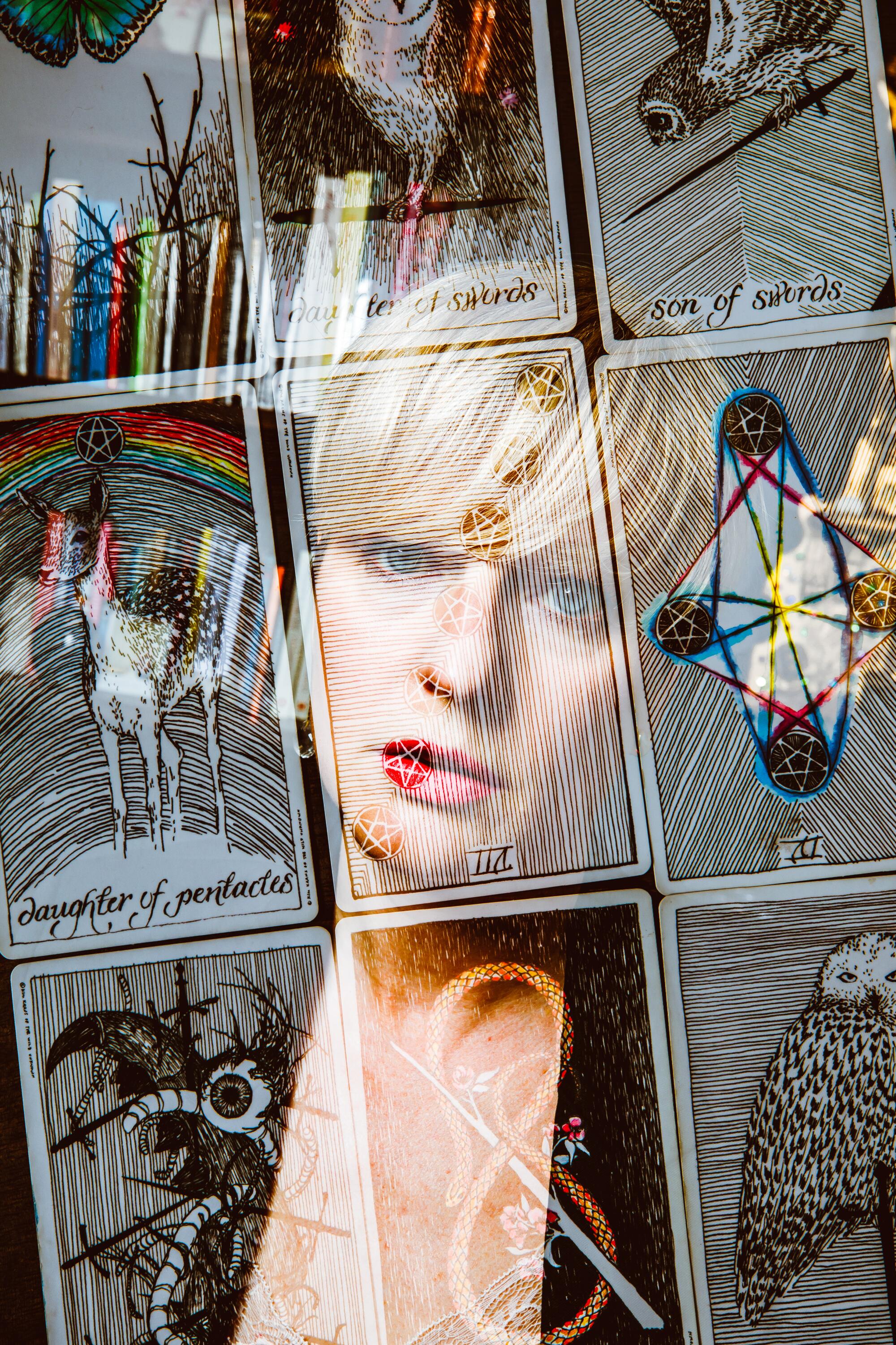 A double exposure of a woman with tarot cards overlaid.