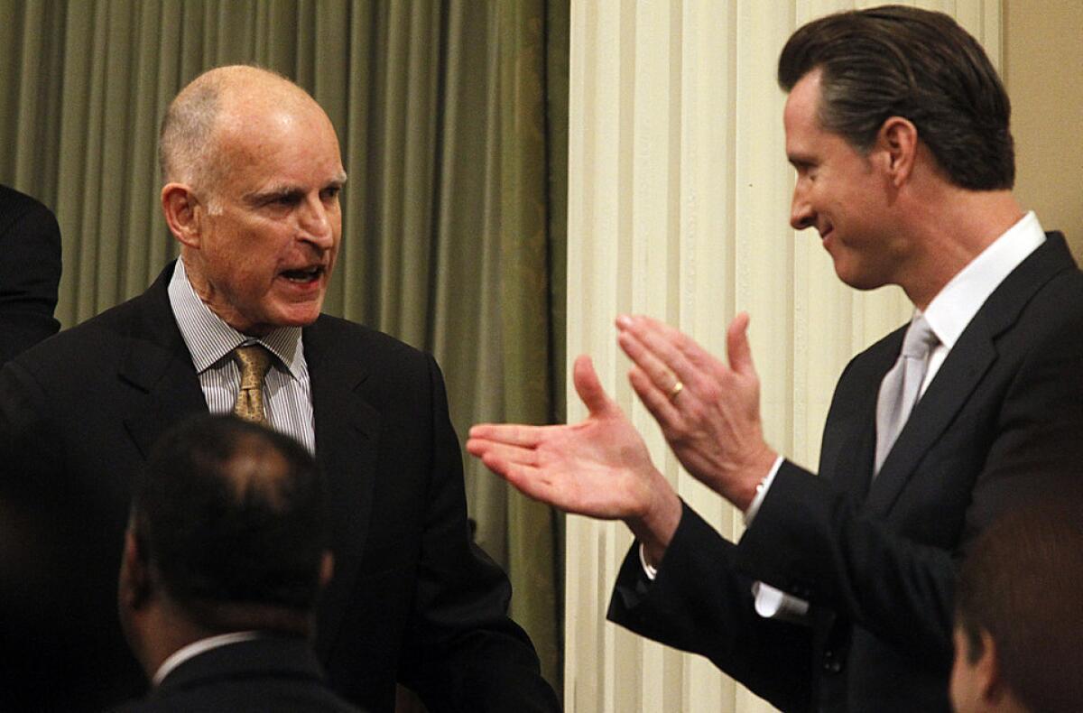 California Gov. Jerry Brown , left, is applauded by Lt. Gov. Gavin Newsom after delivering the state of the state address in January. They are expected to join state Democrats for the party's convention in L.A. on Friday.