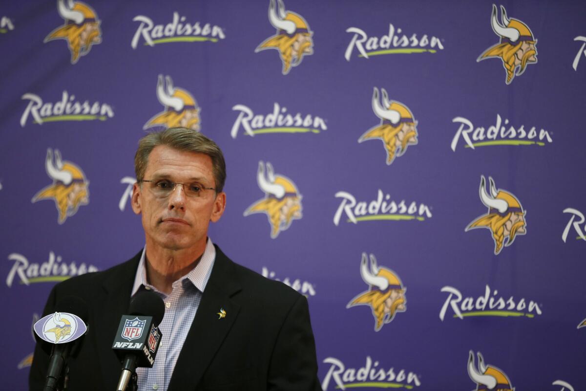 The logo for the Radisson hotel chain appears behind Vikings GM Rick Spielman while he discusses the Adrian Peterson situation Monday.