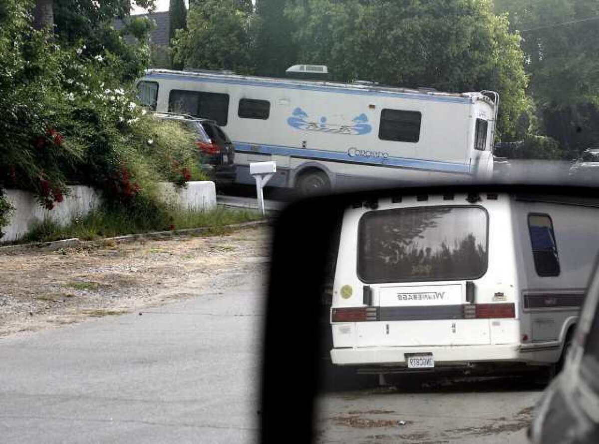 A recreational vehicle parked at 1425 Curran St. is seen in the background and another one parked at a home at the corner of Indiana and Curran is seen in the rear-view mirror in La Canada Flintridge.