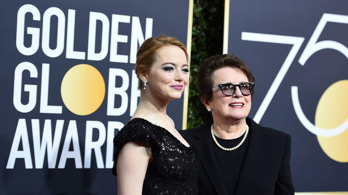 Emma Stone, left, and Billie Jean King arrive at the 75th annual Golden Globe Awards at the Beverly Hilton Hotel on Sunday.