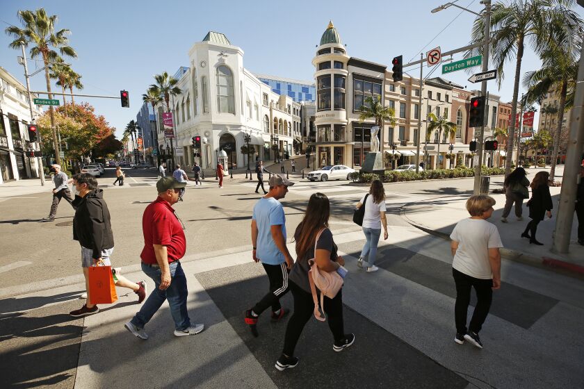 BEVERLY HILLS, CA - OCTOBER 27: Pedestrians on Rodeo Drive near Wilshire Blvd in Beverly Hills Wednesday morning following a news conference on the steps of Beverly Hills City Hall that discussed developments in a class action lawsuit filed against the city alleging racial profiling. Topics discussed include racial data behind recent arrests made by the Rodeo Drive Task Force, the new plaintiffs in the lawsuit, and a newly filed governmental claim and more. Beverly Hills City Hall on Wednesday, Oct. 27, 2021 in Beverly Hills, CA. (Al Seib / Los Angeles Times).