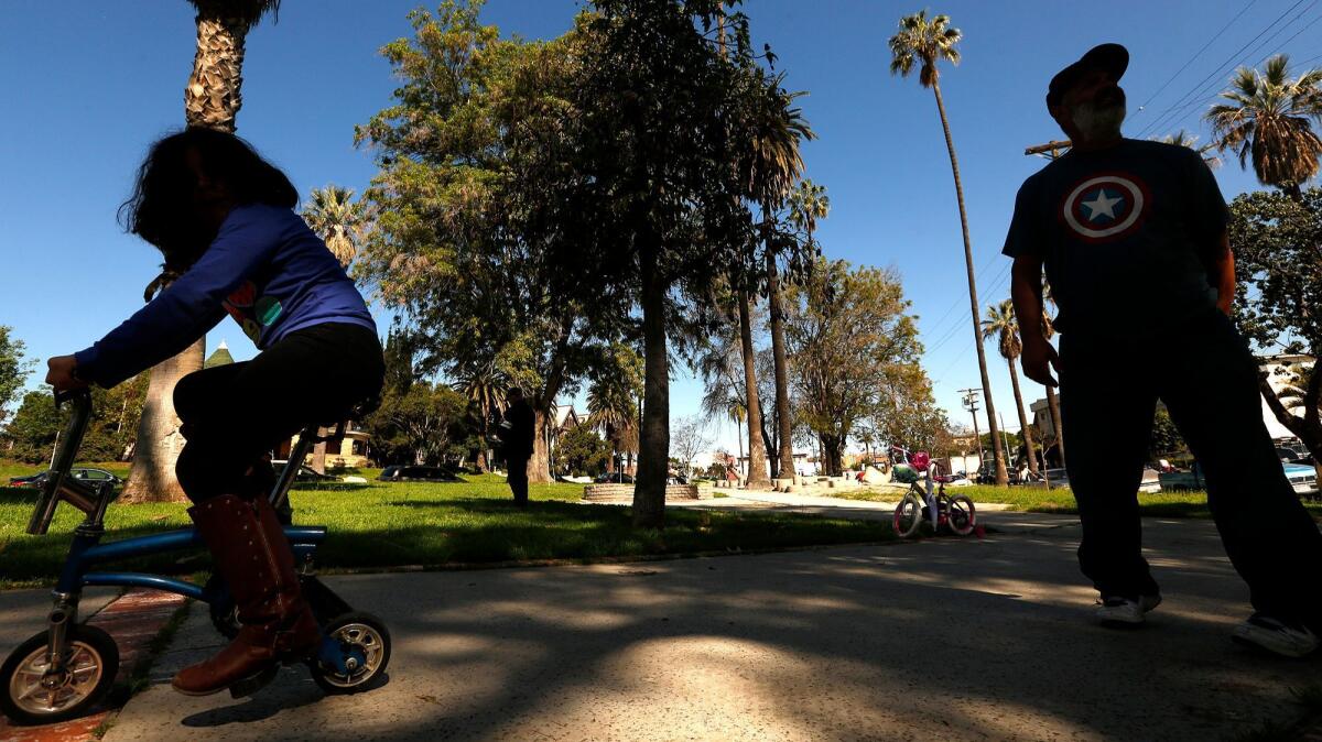 Alf Ximenez, 47 and his daughter Juliana, 7, enjoy their time in Terrace Park in the Pico Union area.