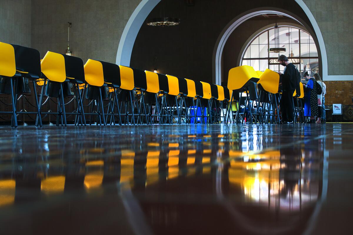 Yellow electronic voting booths set up inside a train station