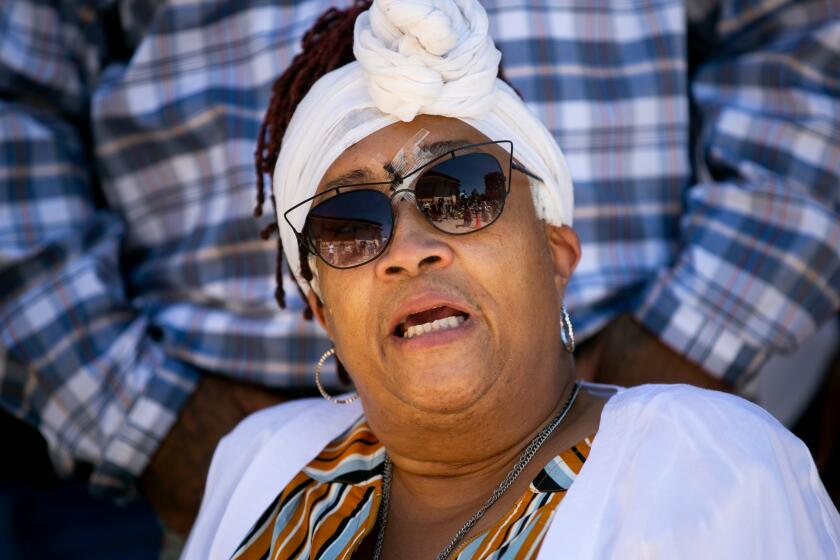 Leslie Furcron, a 59-year-old La Mesa resident who was shot in the head with what appeared to be a bean bag round during a protest, speaks alongside her attorney Dante Pride and her family and supporters at a press conference outside of La Mesa City Hall on June 10, 2020 in La Mesa, California.