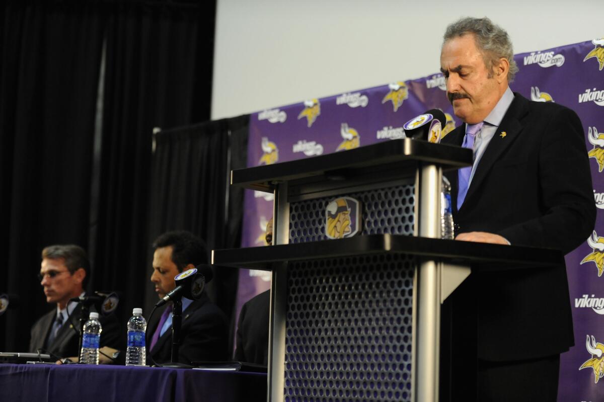 Vikings co-owner Zygi Wolf stands at the podium, with General Manager Rick Spielman, far left, and co-owner Mark Wilf seated nearby, during a Sept. 17 news conference in Eden Prairie, Minn.