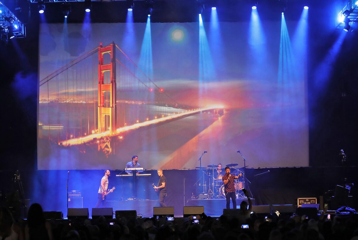 A backdrop is projected of the Golden Gate Bridge as Journey tribute band DSB, (Don't Stop Believin') play "Lights."