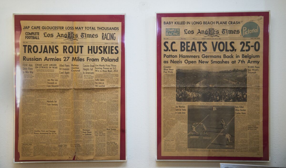 Front pages of newspapers from 1944, left, and 1945 hang on a wall at Jim Hardy's home in La Quinta.