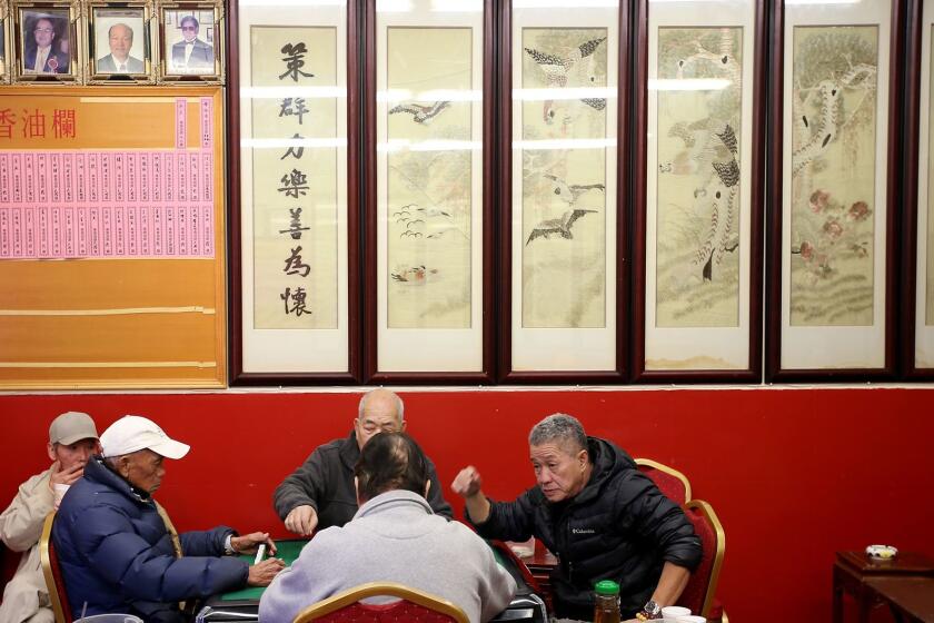 LOS ANGELES, CALIF. - JAN. 27, 2017. A group pf men play mah jong at the Hop Sing Tong Benevolent Association on Friday, Jan. 27, 2017, one day after two men were fatally stabbed at the Chinatown club. (Luis Sinco/Los Angeles Times)