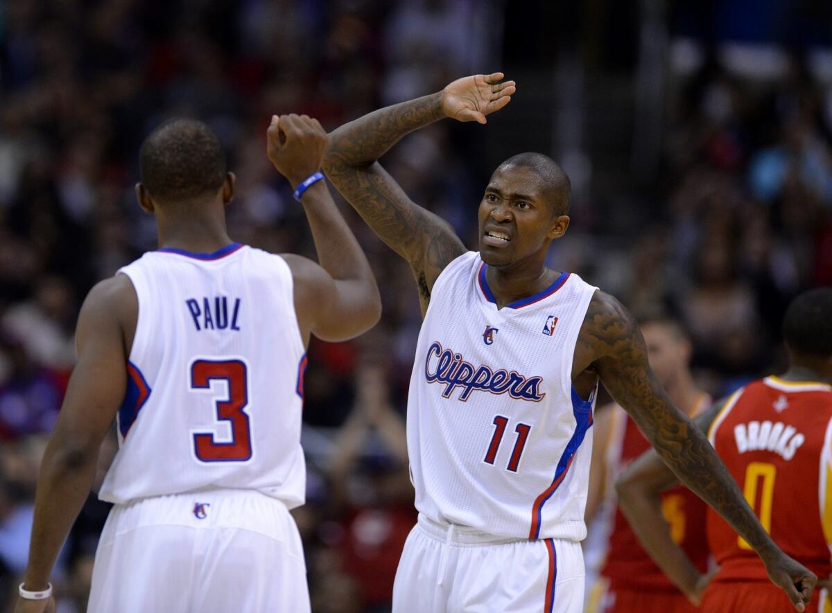 Clippers guard Jamal Crawford, right, celebrates with teammate Chris Paul near the end of the team's 137-118 victory over the Houston Rockets on Monday. The Clippers entered Tuesday as the NBA's highest-scoring team.