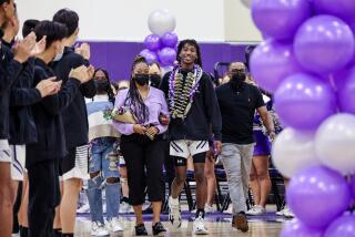 Irvine, CA, Friday, January 28, 2022 - Makai Brown, walks with his sister, Aubrey, far left, mother, Sabrina and father Terrell, right, during a senior celebration at Portola High School before a basketball game against Irvine High School on senior night. Makai and his family have spoken publicly in the last few days about racist comments that were directed at him during a game at Laguna Hills High School recently. (Robert Gauthier/Los Angeles Times)