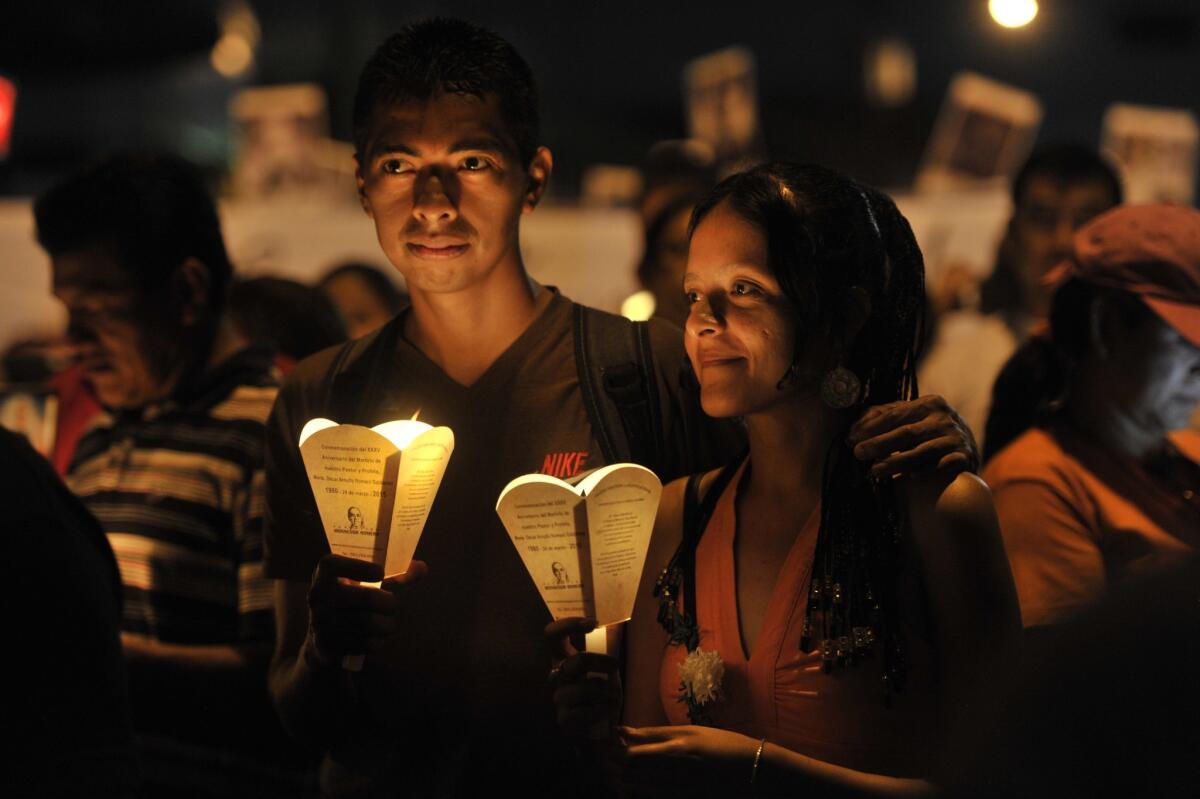 Roman Catholics take part in a pilgrimage of light in San Salvador on Saturday, part of the acts to commemorate the 35th anniversary of the assassination of Archbishop Oscar Romero.
