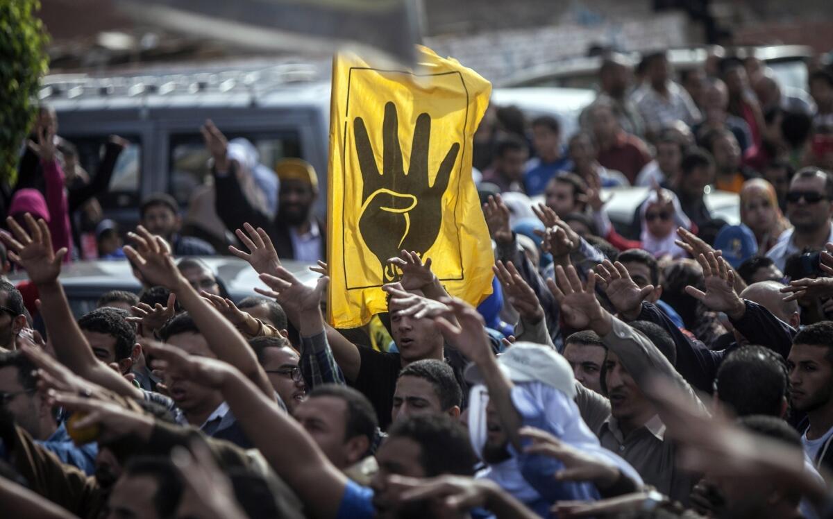 Muslim Brotherhood members and backers of ousted President Mohamed Morsi shout slogans during a demonstration to defy a new law banning unauthorized protests.