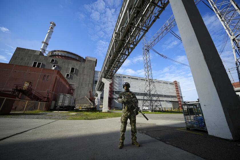 FILE - A Russian serviceman guards in an area of the Zaporizhzhia Nuclear Power Station in territory under Russian military control, southeastern Ukraine, on May 1, 2022. Ukraine's Zaporizhzhia nuclear power plant, the biggest in Europe, has lost its last remaining external power source as a result of renewed shelling and is now relying on emergency diesel generators, the U.N. nuclear watchdog said Saturday, Oct. 8, 2022. (AP Photo, File)