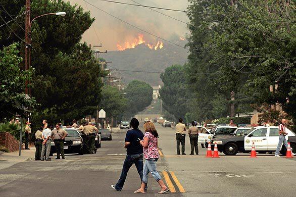 A view of Pennsylvania Avenue in La Crescenta where people gathered to watch the fire raging in the mountains on Tuesday morning.