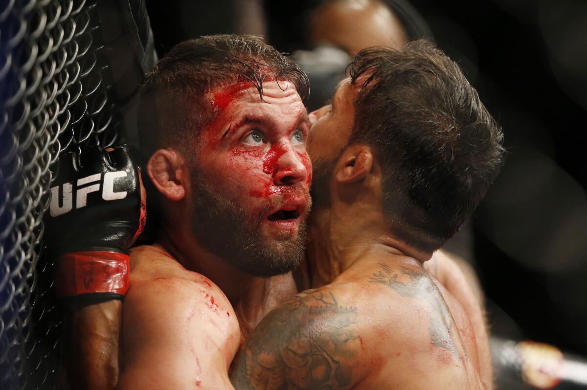 Jeremy Stephens, left, fights Dennis Bermudez during their mixed martial arts bout at UFC 189 on Saturday, July 11, 2015, in Las Vegas. (AP Photo/John Locher)