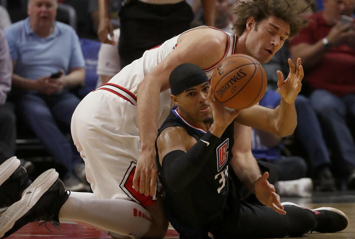 Clippers forward Tobias Harris battles for control of the ball against Bulls center Robin Lopez in the first quarter.