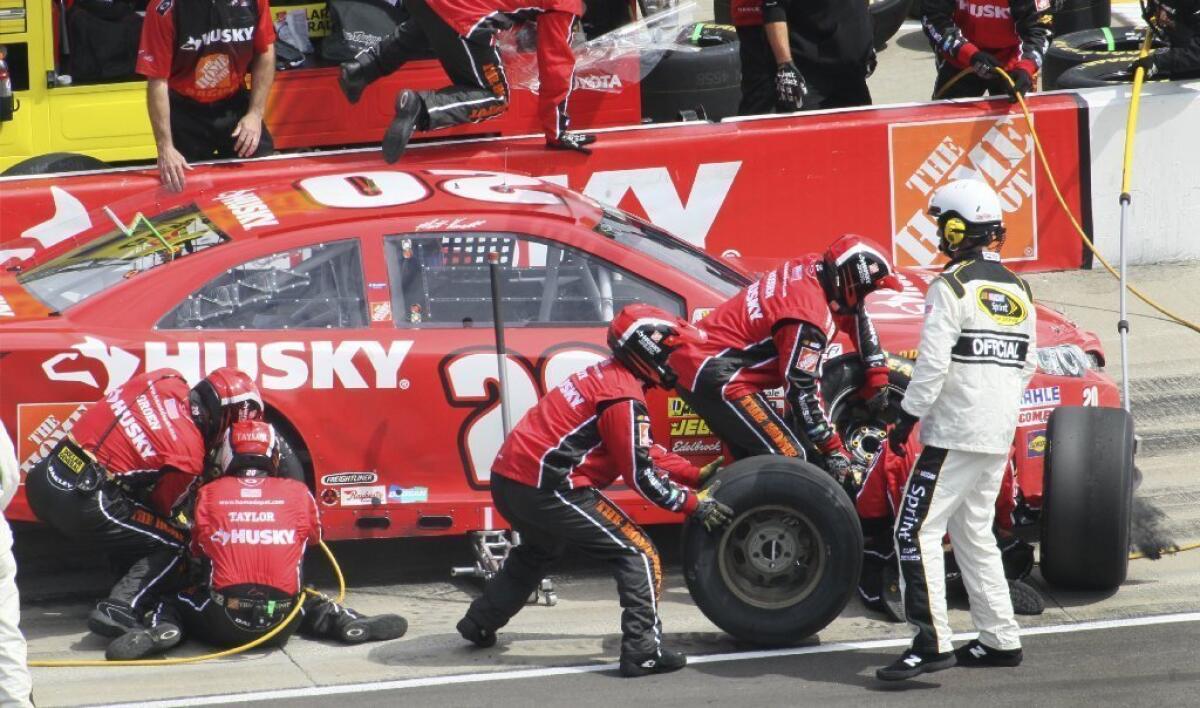 Matt Kenseth and his car in pit row during the NASCAR race at Kansas Speedway.