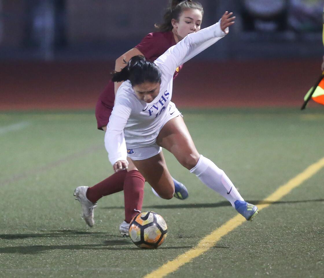 Fountain Valley's Chantelle Sanchez is tripped up by Estancia's Paulina Cortez during girlsÕ soccer team hosts Fountain Valley in a nonleague match