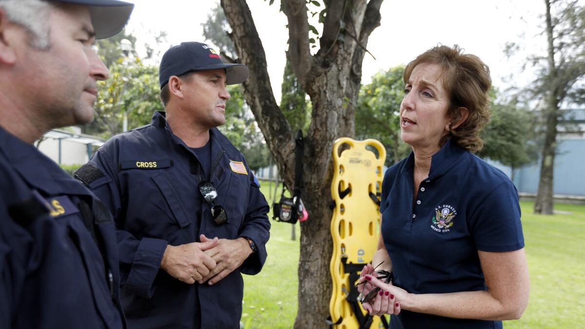 Roberta Jacobson, the U.S. ambassador to Mexico, meets with Los Angeles County Fire Battalion Chiefs Bryan Wells, left, and Dennis Cross at their base camp in Mexico City.