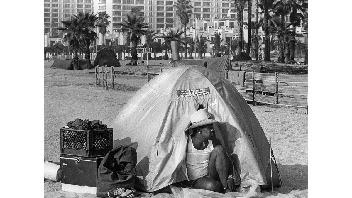 Dec. 1, 1987: A camper on Venice Beach who calls himself the Rev. Mike Estelle sits in his tent.