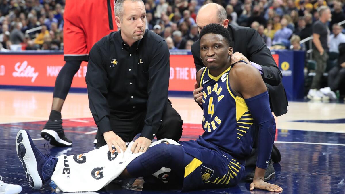 Pacers guard Victor Oladipo is tended to by medical staff after being injured during a game against the Raptors on Jan. 23.