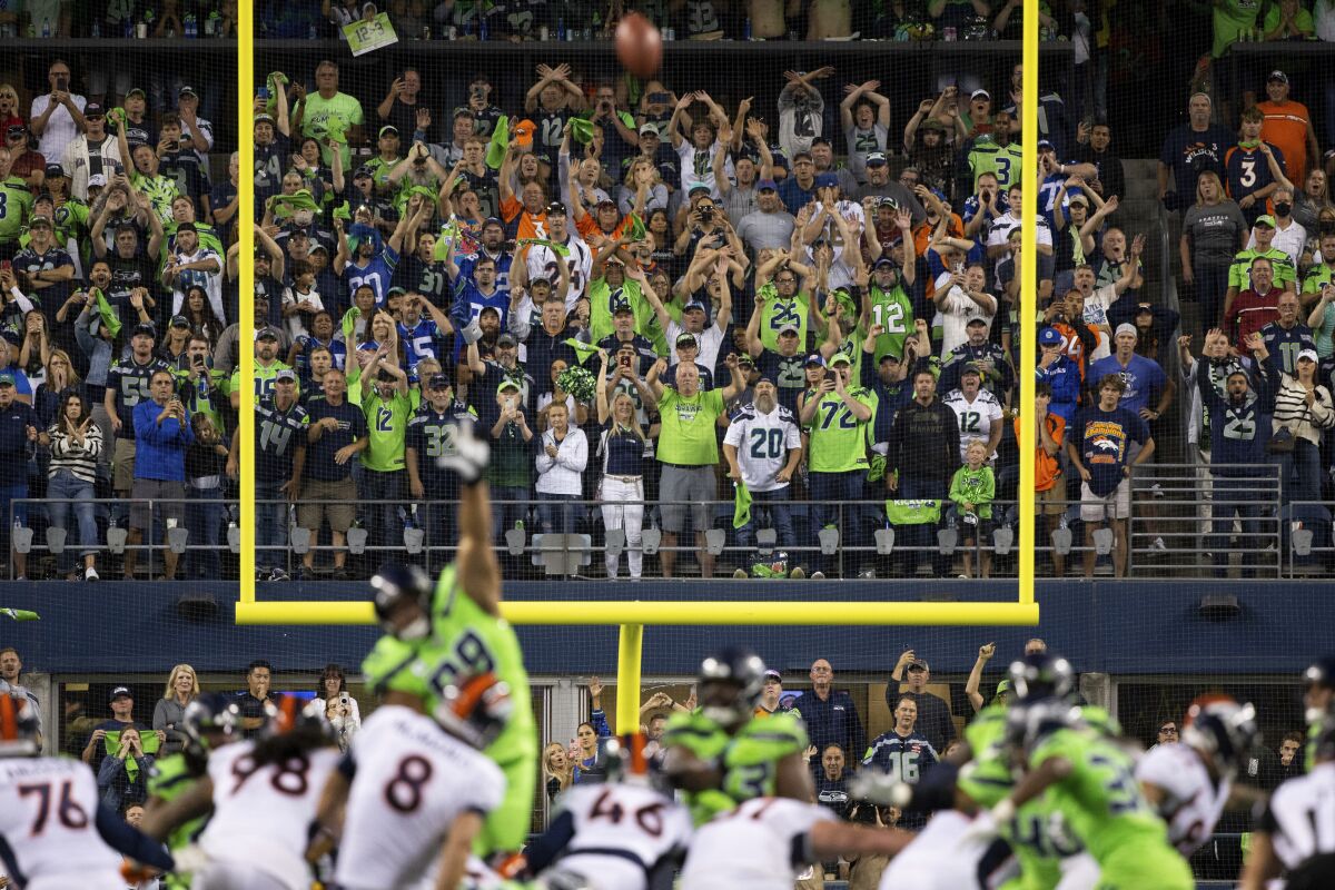 Seattle Seahawks fans cheer as the Denver Broncos miss on a field goal attempt.