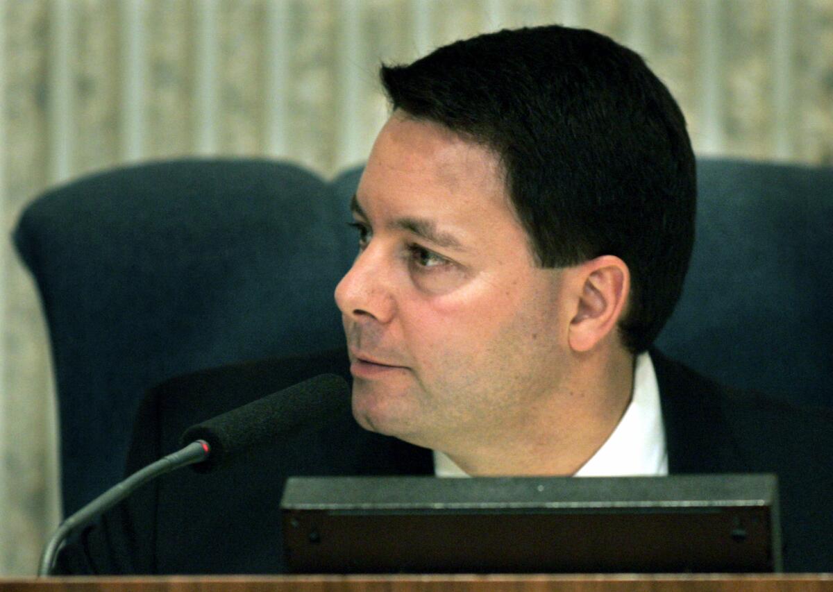 Costa Mesa City Councilman Allan Mansoor, shown during a 2005 meeting, says a website in his name was "hijacked" and repurposed to advertise pornography.