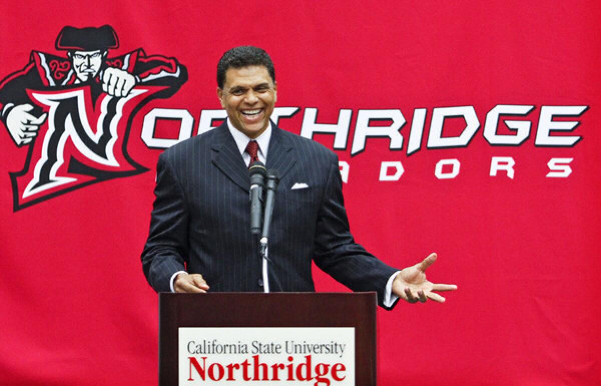 Reggie Theus was all smiles at his news conference announcing the former NBA star as coach at Cal State Northridge.
