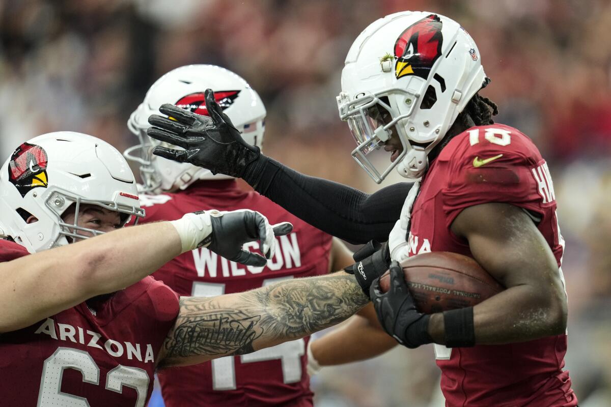 Arizona Cardinals wide receiver Marvin Harrison Jr., right, celebrates after making a touchdown catch.