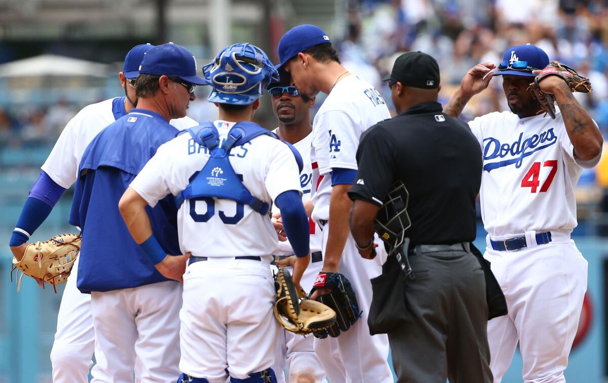 Dodgers pitcher Carlos Frias is pulled in the fifth inning of a game Sunday against the Padres. Frias gave up 10 runs on 12 hits over four innings of work.