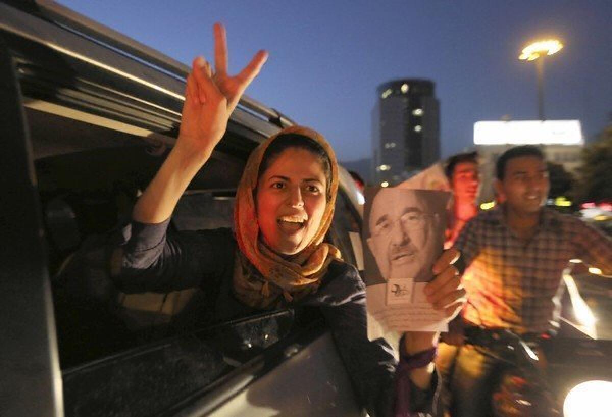 A woman in Tehran's Vanak Square celebrates the victory of Hassan Rowhani in Iran's presidential election. By winning more than half the vote, Rowhani avoided a runoff election.