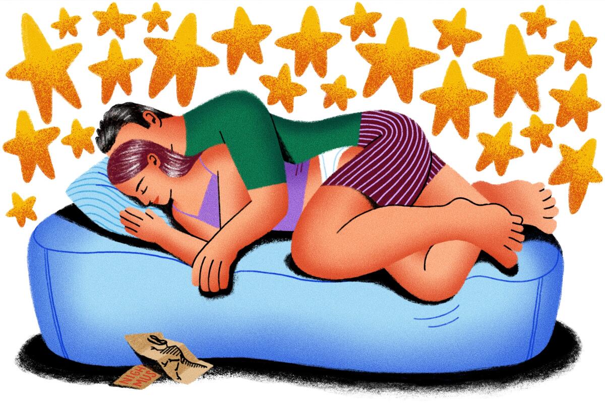 A woman and a man spoon on an air mattress surrounded by stars.