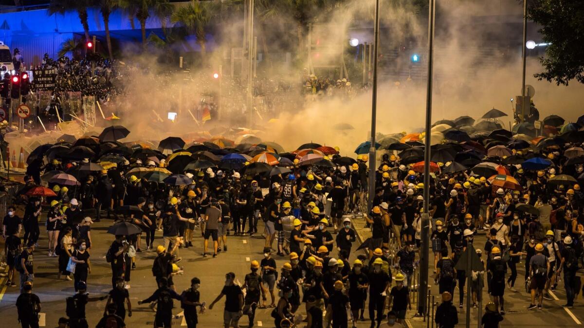 Police fire tear gas as they charge toward protesters outside the Legislative Council complex on July 2, 2019, in Hong Kong.
