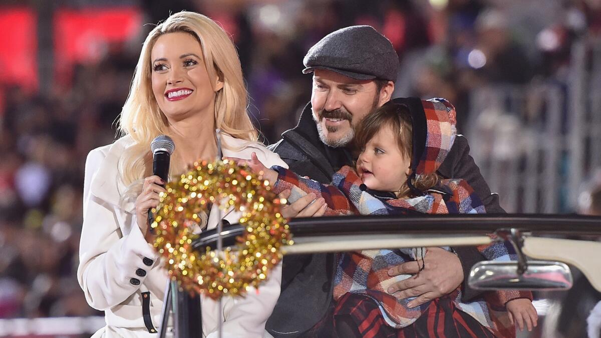 Holly Madison, Pasquale Rotella and daughter Rainbow in the 2015 Hollywood Christmas Parade.