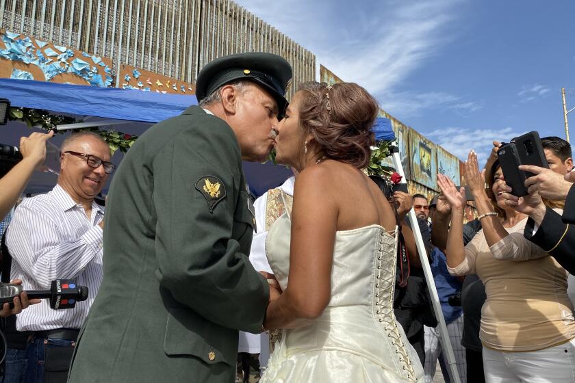 José Francisco López-Moreno, 74, besa a su esposa Florinda Mercado, 64, en ceremonia realizada en el Parque de la Amistad de Playas de Tijuana, México el domingo 22 de septiembre de 2019