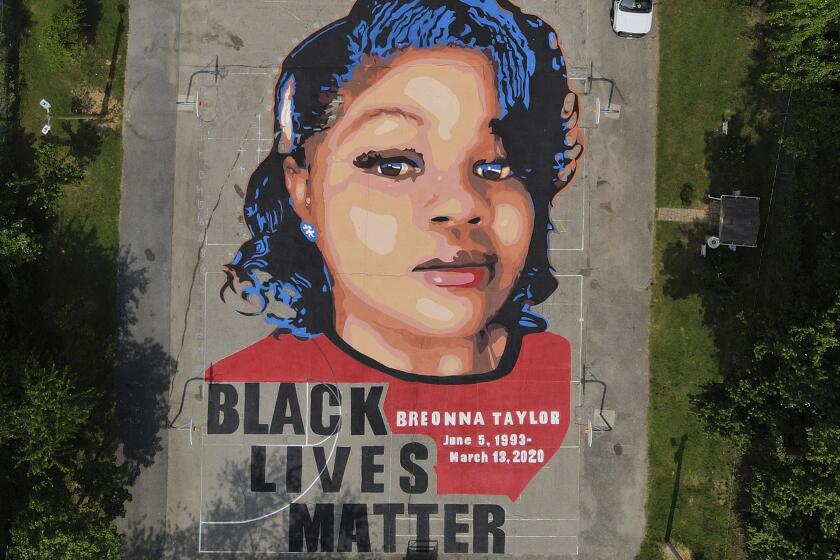 FILE - A ground mural depicting a portrait of Breonna Taylor is seen at Chambers Park in Annapolis, Md., July 6, 2020. The former Louisville Metro Police officer who fatally shot Breonna Taylor has a new job in law enforcement. WHAS-TV reported that the Carroll County Sheriff’s Office confirmed Saturday, April 24, 2023, the hiring of Myles Cosgrove who was fired from the police department in January 2021 for violating use-of-force procedures and failing to use a body camera during the raid on Taylor’s apartment. (AP Photo/Julio Cortez, File)