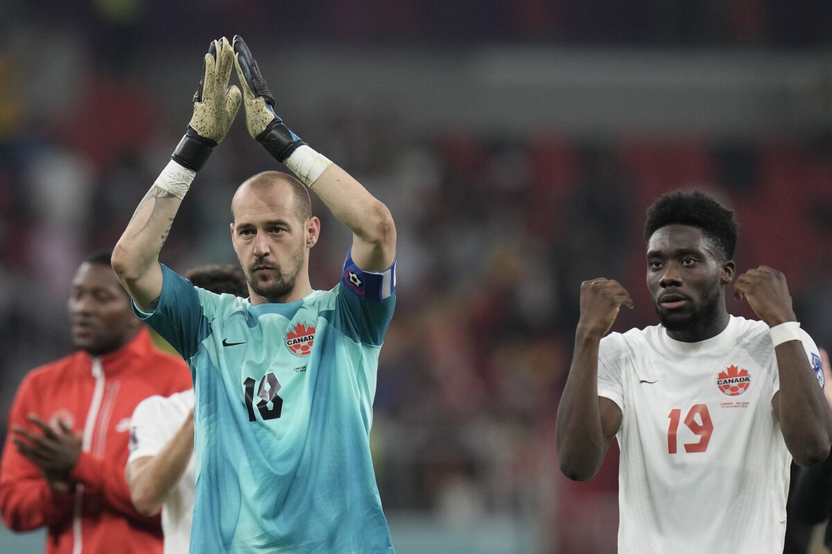 Canada's goalkeeper Milan Borjan, left, and Canada's Alphonso Davies react disappointed after the World Cup group F soccer match between Belgium and Canada, at the Ahmad Bin Ali Stadium in Doha, Qatar, Wednesday, Nov. 23, 2022. (AP Photo/Hassan Ammar)