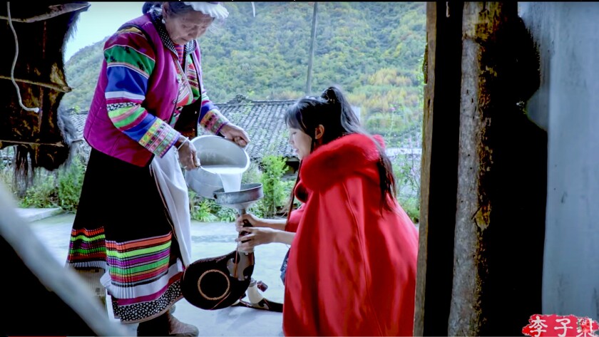 Screenshot from a video of Li Ziqi (right) collecting mare's milk for kumis, a fermented drink. Li Ziqi, who documents life in rural China, is one of the most watched food bloggers in the world.