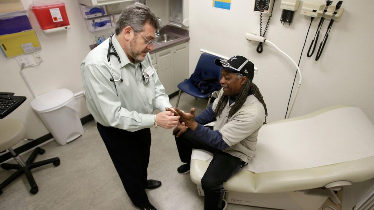 Doctor Leonid Basovich, left, examines Medi-Cal patient Michael Epps, at the WellSpace Clinic in Sacramento, Calif on Feb. 18, 2016.