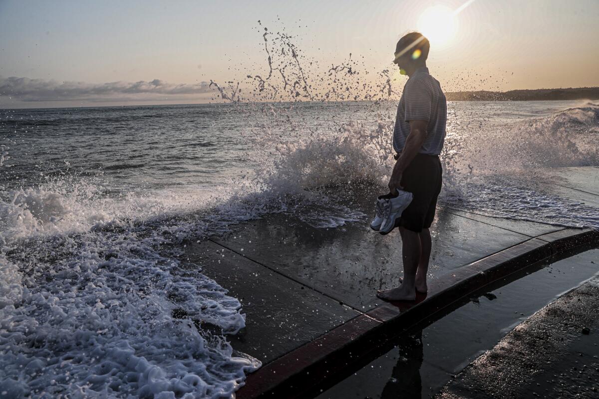 Steve McCormack meets the surf coming ashore at Capistrano Beach on Aug. 19.