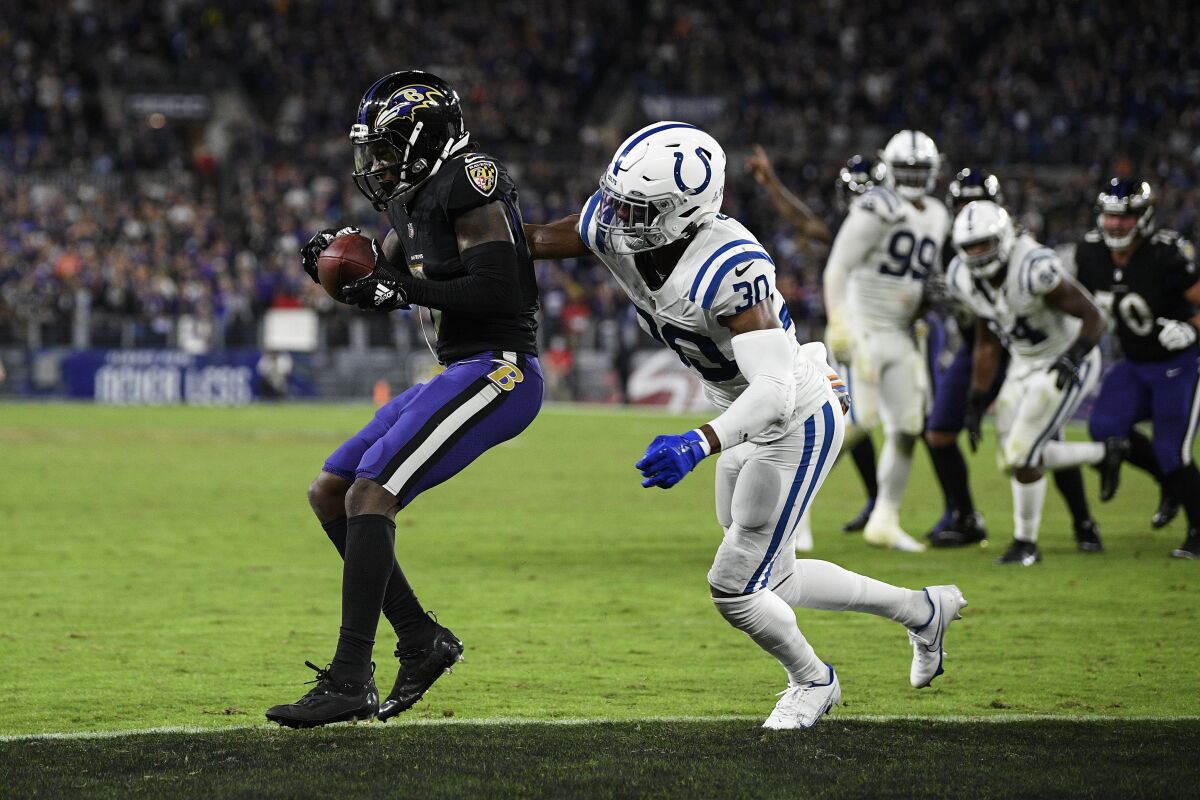 Baltimore Ravens wide receiver Marquise Brown, left, catches the winning pass in front of Indianapolis Colts defensive back George Odum (30) during overtime of an NFL football game Monday, Oct. 11, 2021, in Baltimore. (AP Photo/Nick Wass)