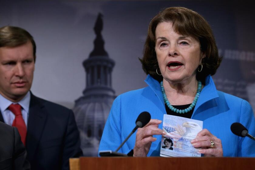 Sen. Dianne Feinstein (D-Calif.) holds up her passport last month during a news conference about Democratic legislative proposals to combat terrorism.