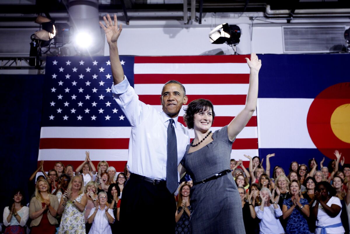 President Obama and Sandra Fluke wave at a campaign event at the University of Colorado in Aurora.