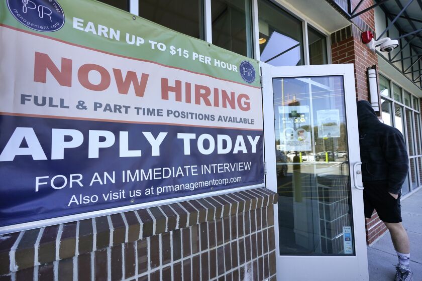 A man walks into a restaurant displaying a "Now Hiring" sign, Thursday, March 4, 2021, in Salem, N.H. U.S. employers added a robust 379,000 jobs last month, the most since October and a sign that the economy is strengthening as confirmed viral cases drop, consumers spend more and states and cities ease business restrictions. (AP Photo/Elise Amendola)