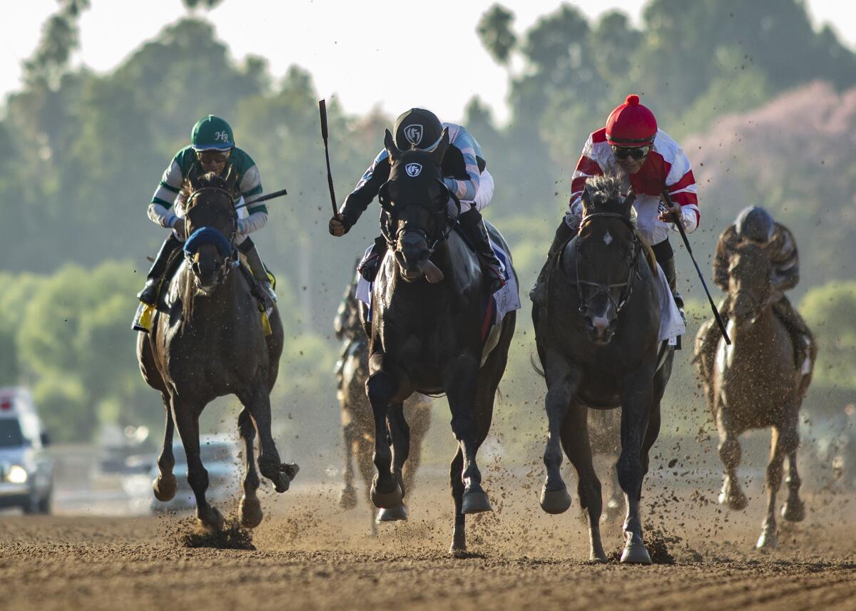 Omaha Beach and jockey Mike Smith, right front, overpower Shancelot, second from left, and Flagstaff, left, to win the Grade I, $300,000 Santa Anita Sprint Championship horse race on Saturday in Arcadia.