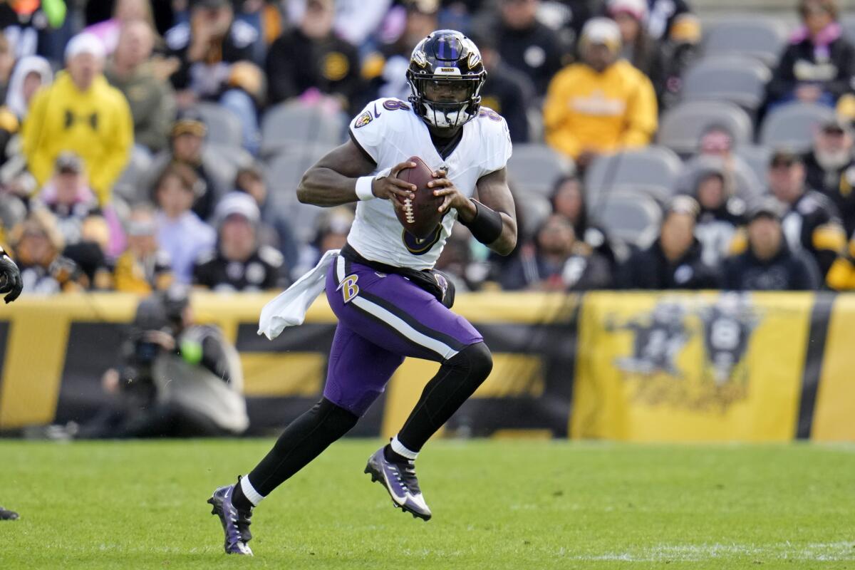 Baltimore Ravens quarterback Lamar Jackson rolls out.