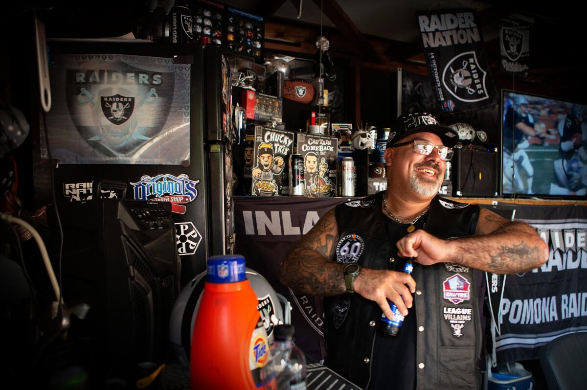 Die-hard Raiders fan Ray Allala stands in his garage-turned-man-cave at his home in Riverside.