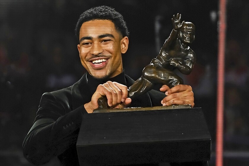Alabama quarterback Bryce Young with his Heisman Trophy 