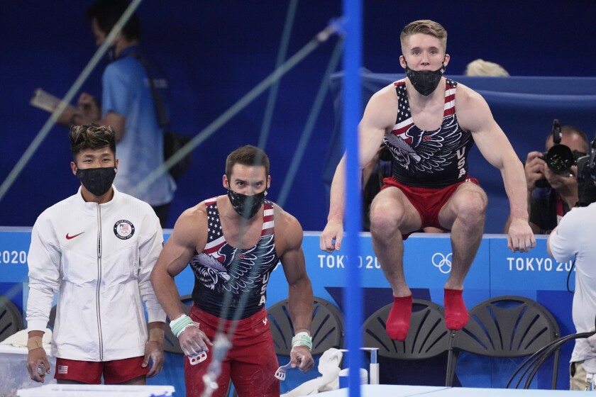 U.S. gymnasts Yul Moldauer, left, Samuel Mikulak and Shane Wiskus watch teammate Brody Malone perform
